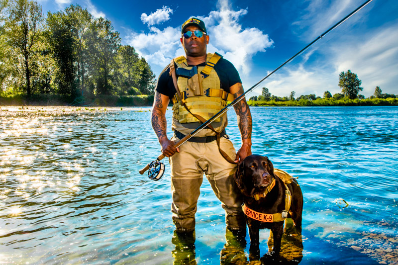Chad and his service dog, Axe, out fishing for steelhead.