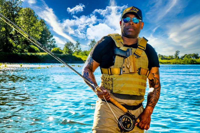 Navy Veteran Chad Brown poses with his fly rod.