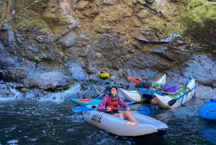 Author Alli Hartz grins on her inflatable kayak right after Mule Creek Canyon on the Rogue River