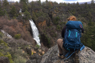 A backpacker examines a waterfall, just one of the many wonders of the Cascade Siskiyou National Monument