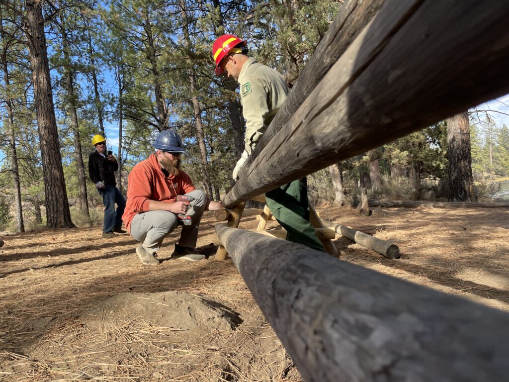 Volunteers put together a fence to protect a riparian area along the Deschutes River.