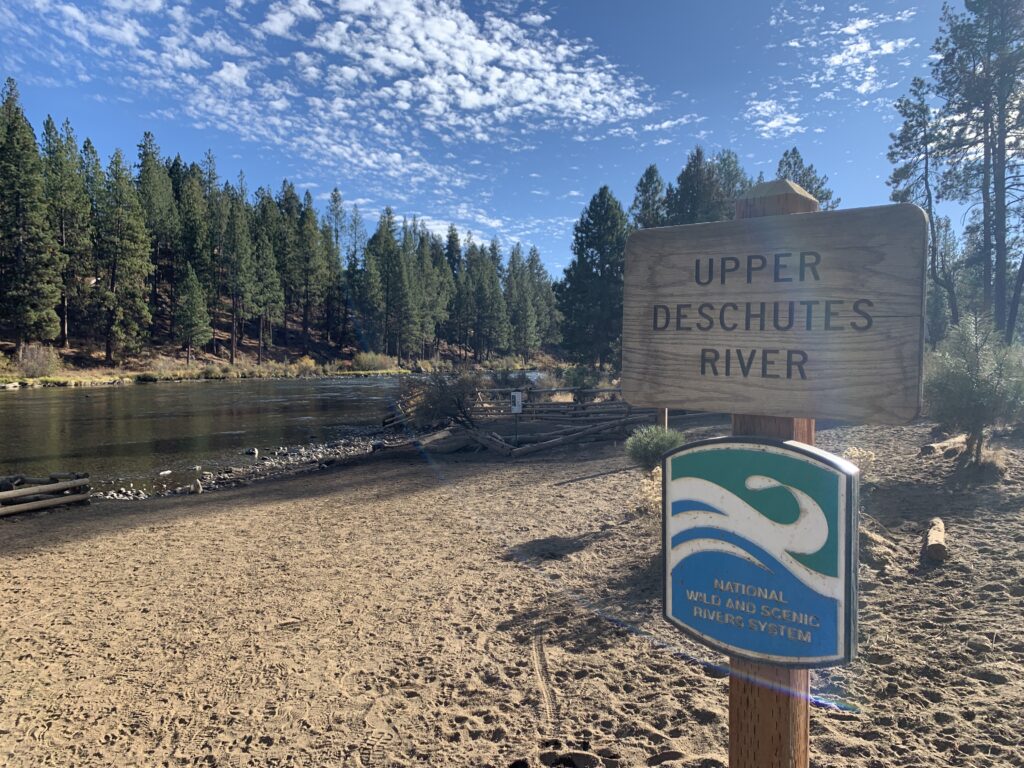 "Upper Deschutes River" Wild and Scenic River sign along the river.